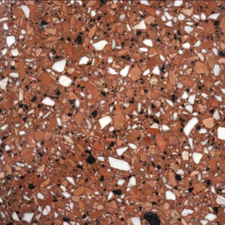 terrazzo fond rouge avec des éclats de pierres noires, grises claires et rouges